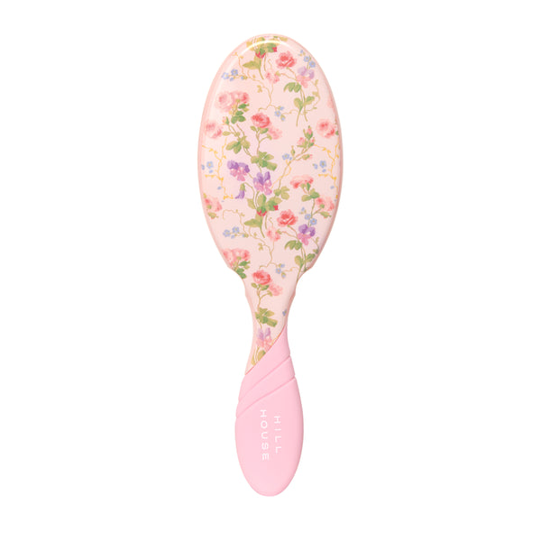 Pink hairbrush with floral pattern on a white background