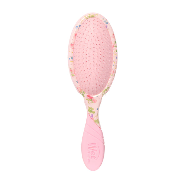 Pink hairbrush with floral pattern on a white background